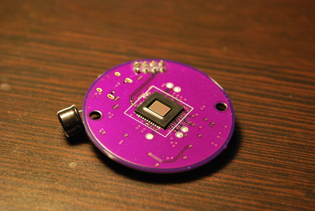 Round purple PCBA with an image sensor at center